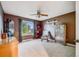 Bedroom with neutral carpet, a ceiling fan, and a large window showcasing outdoor views at 22428 Quail Run Ln, Parker, CO 80138