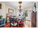 Formal dining room with hardwood floors, chandelier lighting, and abundant natural light at 22428 Quail Run Ln, Parker, CO 80138