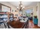 Elegant dining room with chandelier, hardwood floors, and open view to living room at 22428 Quail Run Ln, Parker, CO 80138
