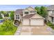 Charming two-story home with manicured lawn, garden beds, and a three-car garage at 22428 Quail Run Ln, Parker, CO 80138