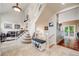 Grand foyer with a staircase, neutral tile, and an open view into the living room at 22428 Quail Run Ln, Parker, CO 80138