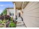 Inviting front porch with flower pots and a decorative column on a two-story home at 22428 Quail Run Ln, Parker, CO 80138