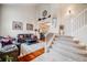 Bright living room with a staircase, hardwood floors, and comfortable seating area at 22428 Quail Run Ln, Parker, CO 80138