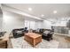 Large living room with furniture, recessed lighting, and access to the bar area at 22428 Quail Run Ln, Parker, CO 80138