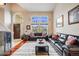 Bright living room with large windows, hardwood floors, and comfortable seating area at 22428 Quail Run Ln, Parker, CO 80138