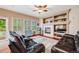 Comfortable living room with a fireplace, built-in shelving, and hardwood floors at 22428 Quail Run Ln, Parker, CO 80138