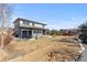Expansive backyard features a covered patio with dining and seating, plus a basketball court at 14100 Blue Wing Ln, Parker, CO 80134