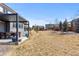 Spacious backyard with a covered patio, dining area, and a lush lawn, ideal for outdoor activities at 14100 Blue Wing Ln, Parker, CO 80134