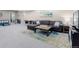 Finished basement living area with large sectional and colorful rug at 14100 Blue Wing Ln, Parker, CO 80134