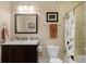 Bathroom featuring a single vanity, toilet, and shower with a patterned curtain at 14100 Blue Wing Ln, Parker, CO 80134