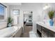 Bright bathroom featuring a soaking tub next to a bedroom view at 14100 Blue Wing Ln, Parker, CO 80134