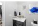 Stylish half bathroom with modern vanity, decorative mirror, and mosaic tile accents at 14100 Blue Wing Ln, Parker, CO 80134