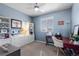 Comfortable bedroom with built-in shelving, a charming desk, and soft, natural light at 14100 Blue Wing Ln, Parker, CO 80134