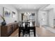 Formal dining room with modern chandelier, a long dark wood table, and plenty of natural light at 14100 Blue Wing Ln, Parker, CO 80134
