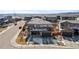 Two-story home with gray siding, stone accents, a dark roof and attached two car garage at 14100 Blue Wing Ln, Parker, CO 80134