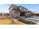 Two-story home with beige and gray siding, a dark roof and an attached two car garage at 14100 Blue Wing Ln, Parker, CO 80134