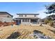 View of backyard showcasing a covered patio with dining and seating areas, plus a sports court at 14100 Blue Wing Ln, Parker, CO 80134