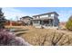 The home features a sprawling backyard with a covered patio and a built-in seating area at 14100 Blue Wing Ln, Parker, CO 80134