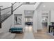 Open-concept foyer with staircase, views into the living room and kitchen, and hardwood floors at 14100 Blue Wing Ln, Parker, CO 80134