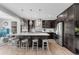 Modern kitchen with dark cabinetry, quartz countertops, stainless steel appliances, and pendant lighting at 14100 Blue Wing Ln, Parker, CO 80134