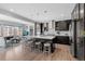 Open concept kitchen with stainless appliances, center island, bar stool seating, and designer pendant lights at 14100 Blue Wing Ln, Parker, CO 80134