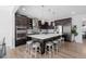 Spacious kitchen with large island, seating for four, stainless steel appliances, and custom backsplash at 14100 Blue Wing Ln, Parker, CO 80134
