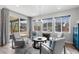 Bright living room with large windows, stylish furniture, and sliding glass door to the backyard at 14100 Blue Wing Ln, Parker, CO 80134