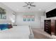 Bright bedroom with a full bed and a TV, with art on the walls at 14100 Blue Wing Ln, Parker, CO 80134