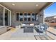 Cozy covered patio with comfortable seating and a modern fire pit, great for outdoor relaxation at 14100 Blue Wing Ln, Parker, CO 80134
