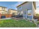 Backyard view shows a well-maintained lawn and a deck with outdoor seating at 6893 Decatur St, Denver, CO 80221
