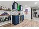 Finished basement bar area has custom cabinetry, brick backsplash, a wine cooler and wood-look flooring at 6893 Decatur St, Denver, CO 80221