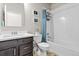 Bright bathroom features a shower-tub combo and a modern vanity with white countertops at 6893 Decatur St, Denver, CO 80221