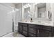 Elegant bathroom with double sink vanity, modern mirrors, a walk-in shower, and sleek fixtures, offering a spa-like experience at 6893 Decatur St, Denver, CO 80221