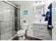 This bathroom features a glass enclosed shower and modern vanity with stone counter tops at 6893 Decatur St, Denver, CO 80221