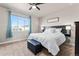 Inviting bedroom with a large window, headboard, comfortable bed, ottoman, and neutral walls, creating a serene retreat at 6893 Decatur St, Denver, CO 80221