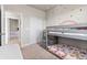 Charming bedroom featuring a bunk bed, rainbow decor, carpet, and a closet, perfect for a creative space at 6893 Decatur St, Denver, CO 80221
