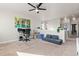 Open bonus room featuring neutral walls, carpet, a half wall, and cozy seating, great for entertaining or relaxing at 6893 Decatur St, Denver, CO 80221