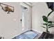 Bright entryway featuring a stylish front door, modern decor, and wood flooring at 6893 Decatur St, Denver, CO 80221