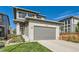 Charming two-story home featuring a well-manicured lawn and an attached two-car garage at 6893 Decatur St, Denver, CO 80221