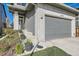 Two-story home featuring a well-manicured lawn, white brick accents and an attached two-car garage at 6893 Decatur St, Denver, CO 80221