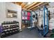 Basement gym featuring ample storage, a weight rack, and durable rubber flooring at 6893 Decatur St, Denver, CO 80221
