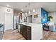 Open concept kitchen with stainless steel appliances, a large island, and views of the living area at 6893 Decatur St, Denver, CO 80221