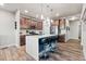 Modern kitchen with an island, stainless steel appliances, wood cabinets, and wood flooring at 6893 Decatur St, Denver, CO 80221