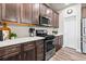 Spacious kitchen featuring stainless steel appliances, and wood cabinetry, complemented by wood flooring at 6893 Decatur St, Denver, CO 80221