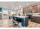 Modern kitchen with an island, stainless steel appliances, and wood flooring at 6893 Decatur St, Denver, CO 80221