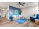 Cozy living room with comfortable seating, stylish decor, and a soothing blue accent wall at 6893 Decatur St, Denver, CO 80221