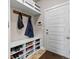 Mud room featuring built-in storage, shoe racks, and coat hooks, ideal for organization at 6893 Decatur St, Denver, CO 80221