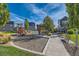 Community playground featuring play equipment, a covered bench, and manicured landscaping at 6893 Decatur St, Denver, CO 80221