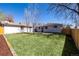 Expansive backyard featuring a lush lawn, a patio, privacy fence, and a detached garage at 7977 Durango St, Denver, CO 80221