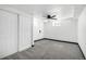 This bedroom features neutral carpet, white walls, a ceiling fan and closet, ready for personalization at 7977 Durango St, Denver, CO 80221
